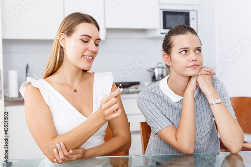 Fotografie Portrait of two girls, one of them showing her engagement ring to her upset frie