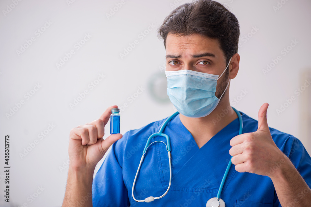 Young male doctor in vaccination concept during pandemic Young male doctor in vaccination concept during pandemic