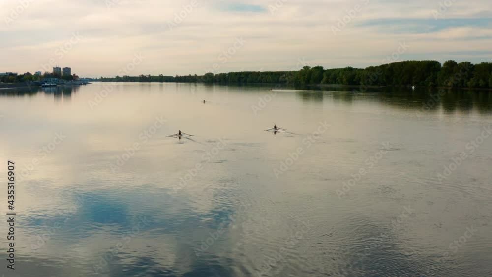 Peaceful Danube River With People Rowing At Sunset Near Vukovar City, Croatia. - Aerial Wide Shot Peaceful Danube River With People Rowing At Sunset Near Vukovar City, Croatia. - Aerial Wide Shot