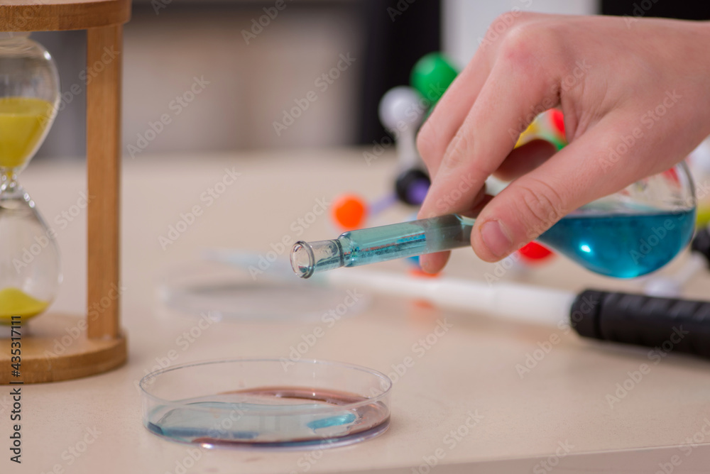 Schoolboy studying chemistry in the classroom Schoolboy studying chemistry in the classroom