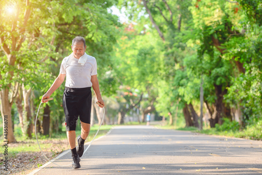 Asian elderly man or senior male Active and healthy Rope skipping exercise In the natural environment in the park