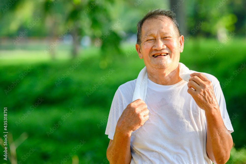 Asian elderly man or senior runner Smile happily In jogging Outdoor and walking workouts in the park Asian elderly man or senior runner Smile happily In jogging Outdoor and walking workouts in the park