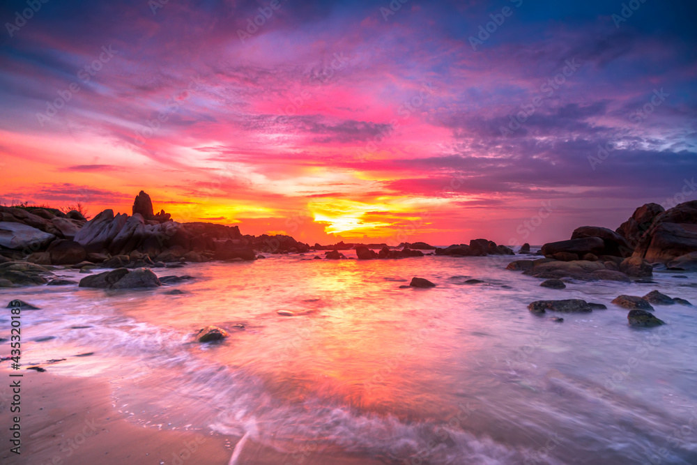 Beautiful sunrise on the beach below the waves lapping at the shore of the soft great to welcome the peaceful new day Beautiful sunrise on the beach below the waves lapping at the shore of the soft great to welcome the peaceful new day