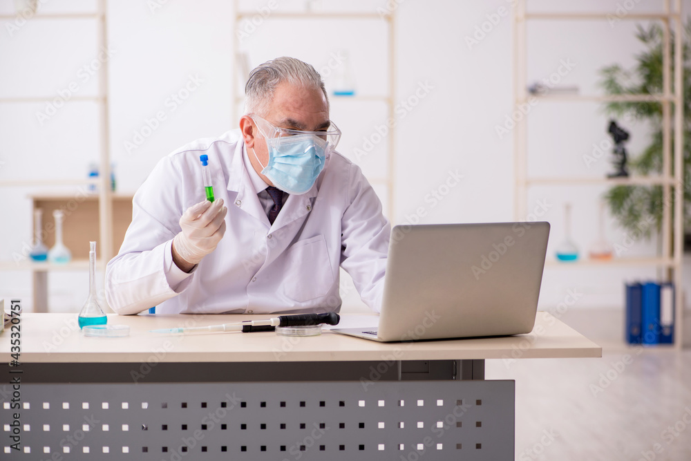 Old male chemist working in the lab during pandemic Old male chemist working in the lab during pandemic