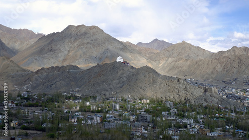 Himalaya mountains with a temple on the top view from the ground © ChanritPae