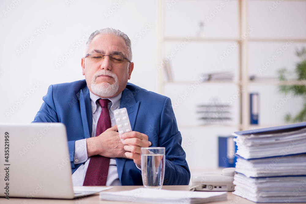 Old male employee and too much work in the office Old male employee and too much work in the office