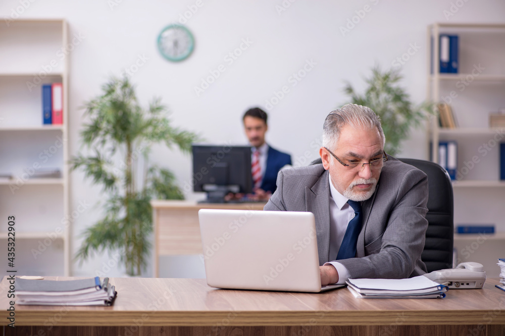 Two male employees working in the office Two male employees working in the office