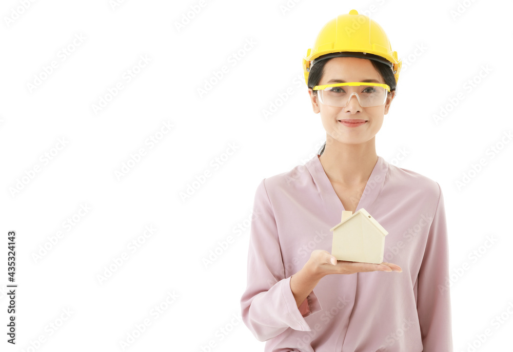 Portrait closeup isolated cutout shot of young smart Asian female construction engineer wears yellow safety hat and goggles stand smile look at camera holding design wooden concept home model in hand Portrait closeup isolated cutout shot of young smart Asian female construction engineer wears yellow safety hat and goggles stand smile look at camera holding design wooden concept home model in hand