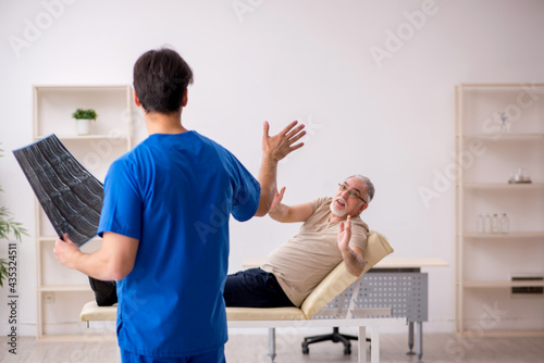 Old male patient visting young male doctor radilogist photo