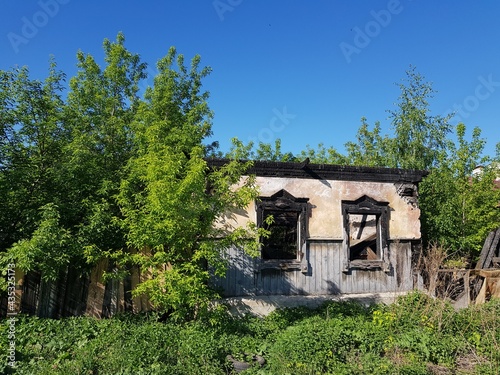 Old abandoned burned down village house