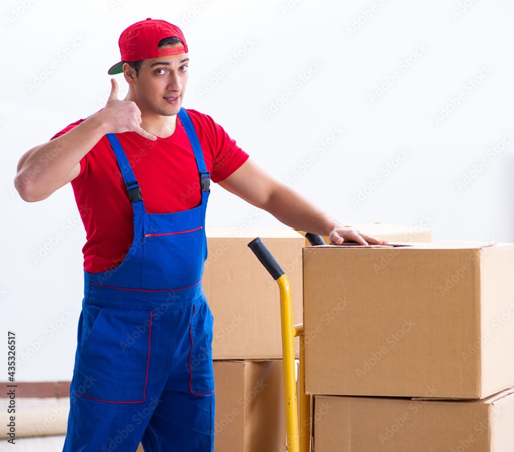 Contractor worker moving boxes during office move Contractor worker moving boxes during office move