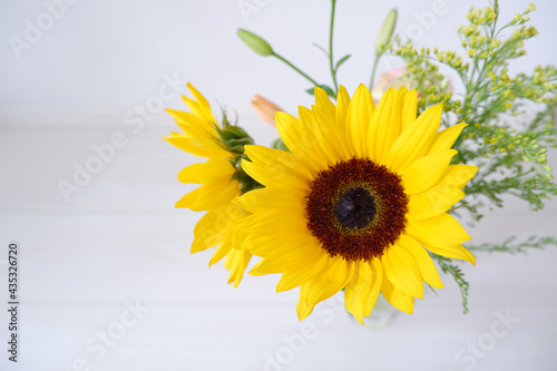 Summer greeting concept. Full bloomed sunflowers decorate indoors. Sunflower vase with on white background. Summer background, wallpaper, web, design elements.