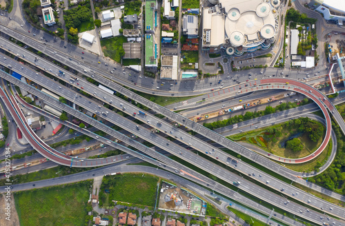 Aerial top view of transportation with Expressway, Road and Roundabout, multilevel junction traffic highway-Top view. Important infrastructure and transport in big city, Bangkok Thailand. photo