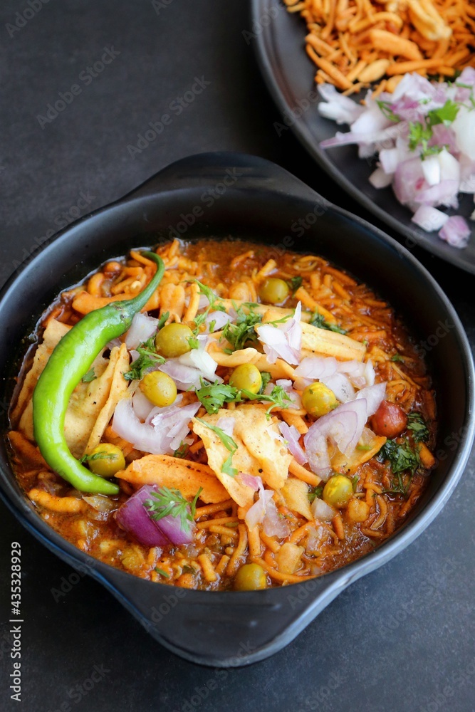 Spicy Misal Pav or usal Pav is a traditional snack or Chaat food from Maharashtra, India. Served with chopped onion, lemon wedges and farsan. Selective focus with copy space Spicy Misal Pav or usal Pav is a traditional snack or Chaat food from Maharashtra, India. Served with chopped onion, lemon wedges and farsan. Selective focus with copy space