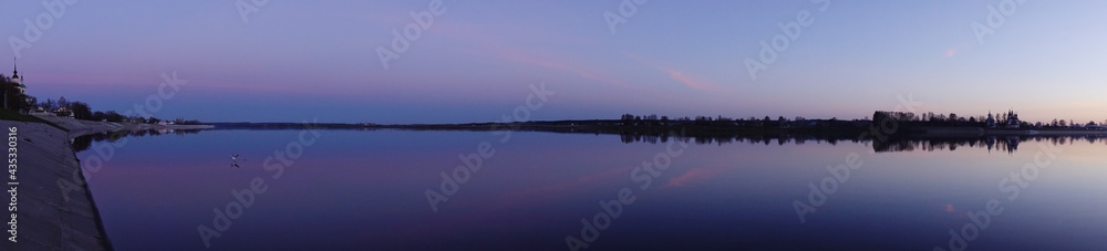 Panorama of the wide river on a summer evening.