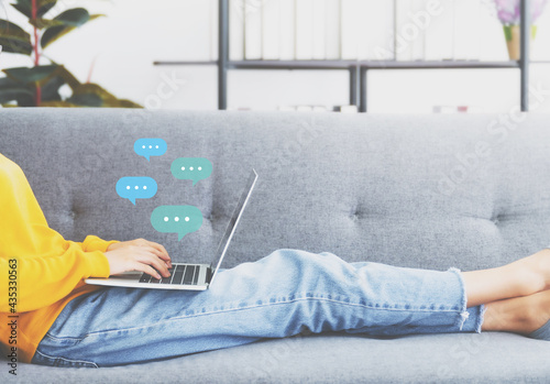 Woman using computer laptop on sofa. Online live chat chatting on application communication digital media website and social network