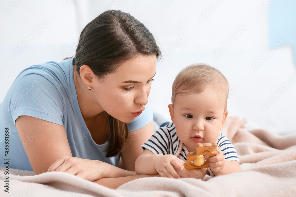 Mother playing with cute baby at home, closeup Mother playing with cute baby at home, closeup