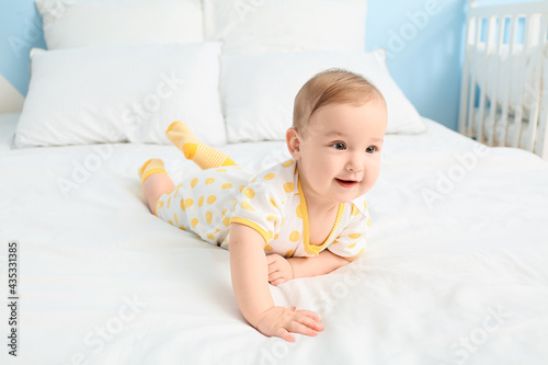 Cute little baby lying on bed