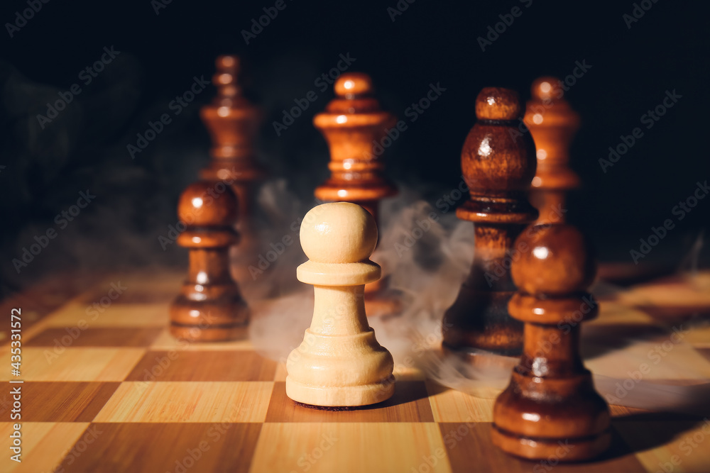 Game board with chess pieces on dark background Game board with chess pieces on dark background