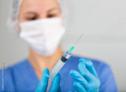 Doctor prepares the syringe for vaccination