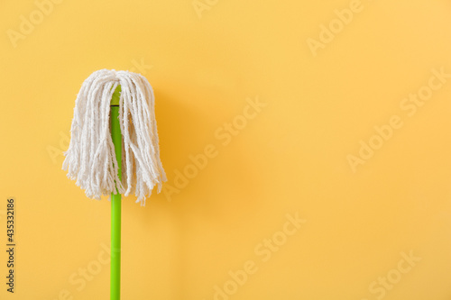 Floor mop on color background photo