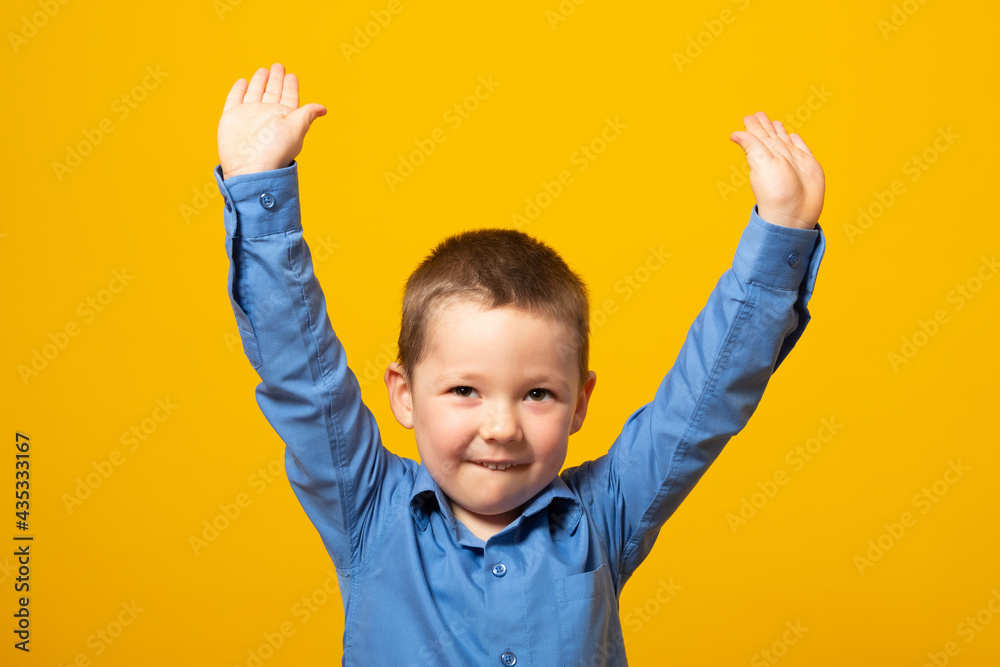 Portrait of happy joyful beautiful little boy isolated on yellow background. Portrait of happy joyful beautiful little boy isolated on yellow background.