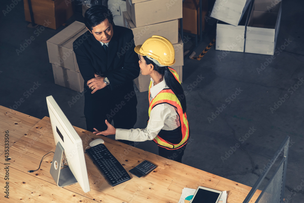 Fotografie Warehouse manager and worker working in the storehouse