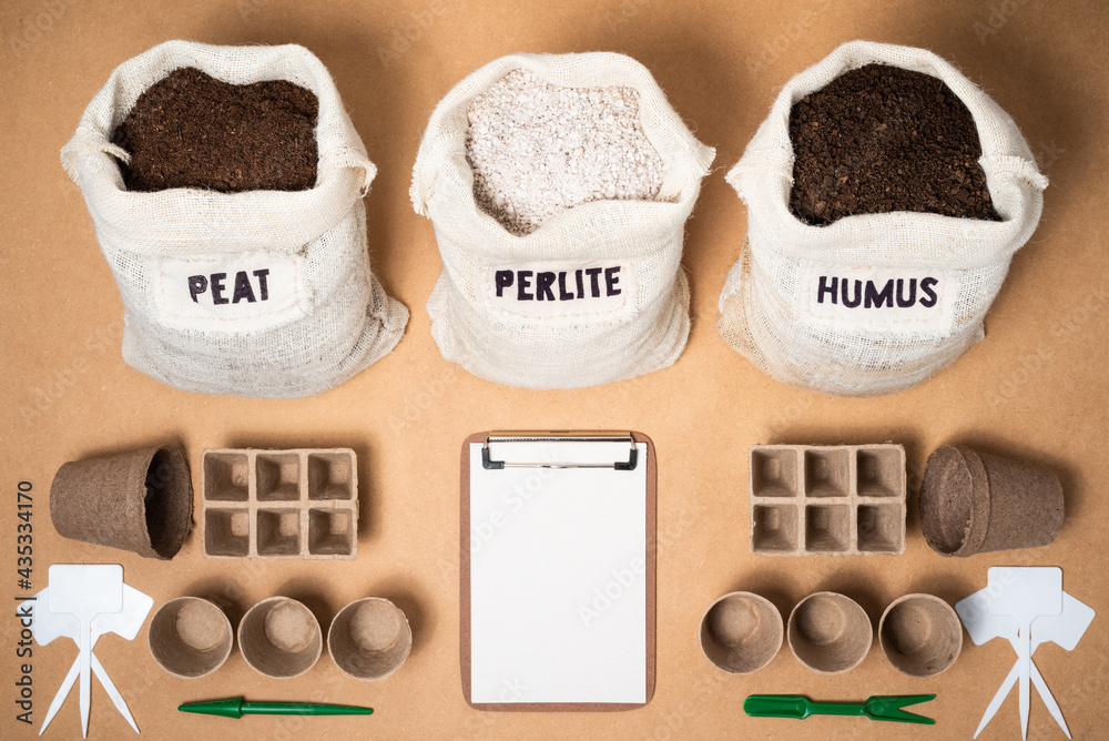 Peat moss, perlite and worm humus as potting soil mix in rustic fabric bags  with a