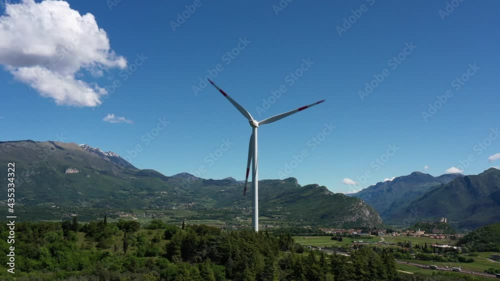 Wind farm in the Alpine nature. Wind turbine in Affi, Lake Garda. Wind generators in the mountains of Italy. Windmill surrounded by olive trees, vineyards, Alps. Wind turbine in Italy. Wind farm in the Alpine nature. Wind turbine in Affi, Lake Garda. Wind generators in the mountains of Italy. Windmill surrounded by olive trees, vineyards, Alps. Wind turbine in Italy.