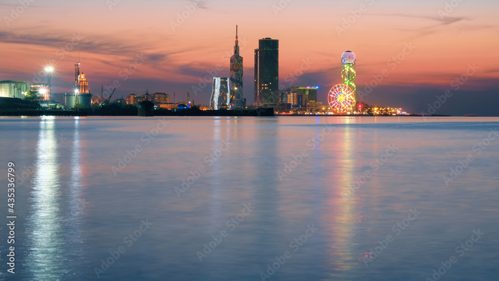 Sunset view of the city line with reflections on the water, Batumi Georgia