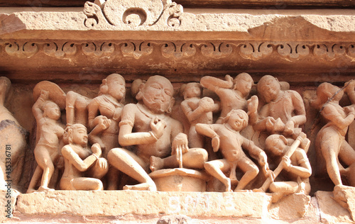 Ffigures of dancing musicians at temple, Khajuraho, India photo