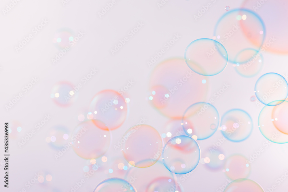 Beautiful Pink and Blue Soap Bubbles Floating on White Background. Soap Sud Bubbles Water.	