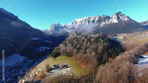 Drone shooting winter wonderland with beautiful snowy landscape, aerial overlooking scenery of hills on top of big mountains in Austrian alps in Vorarlberg