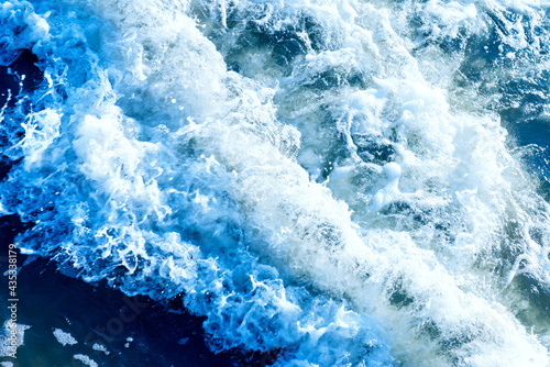 Deep blue and rough sea with lot of sea spray.Blue background.Soft focus,blurred image.