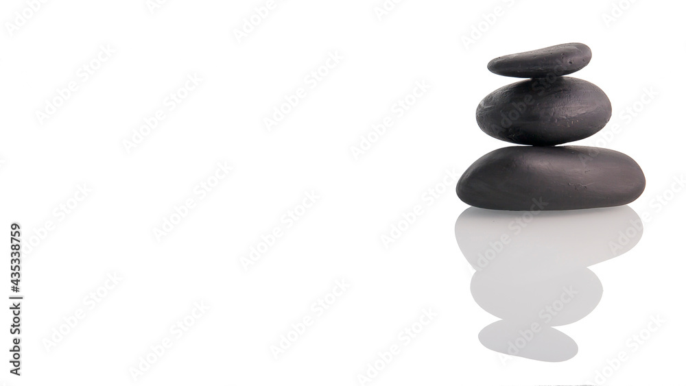 Zen concept balancing dark stones on mirrored background Zen concept balancing dark stones on mirrored background
