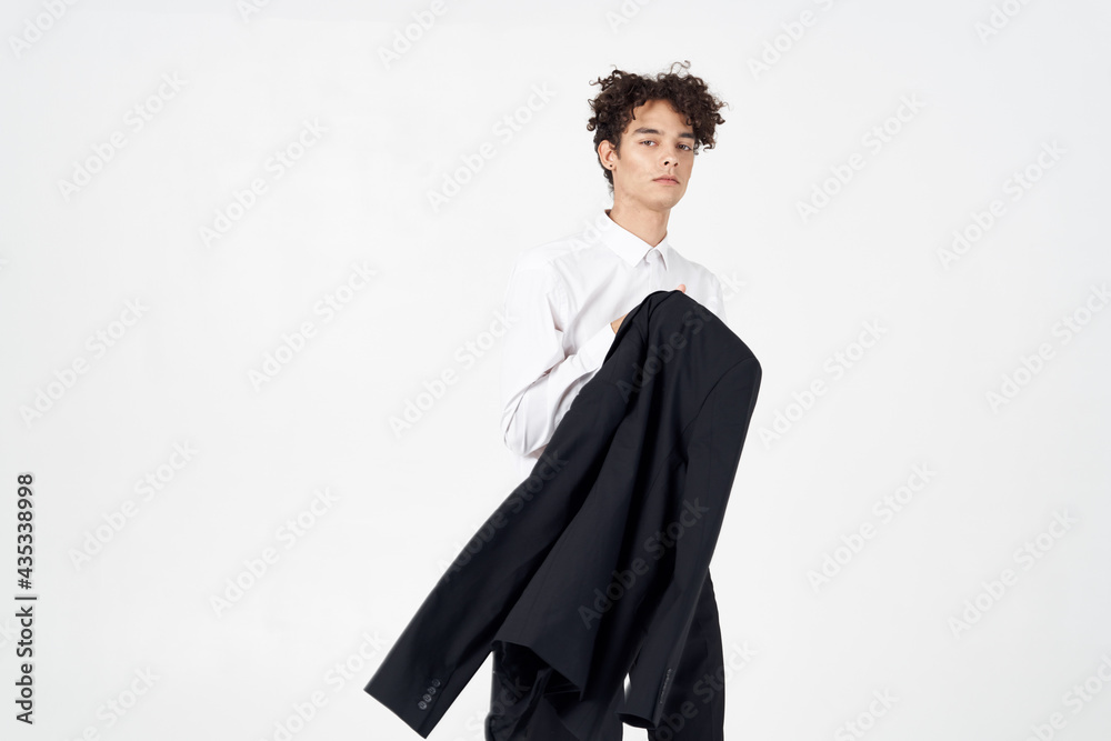 curly guy in a jacket shirt and trousers on a light background cropped view of the model curly guy in a jacket shirt and trousers on a light background cropped view of the model