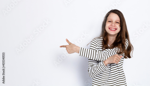 Funny dark-haired girl shows class gesture with her hands. On a light background. Space for text.