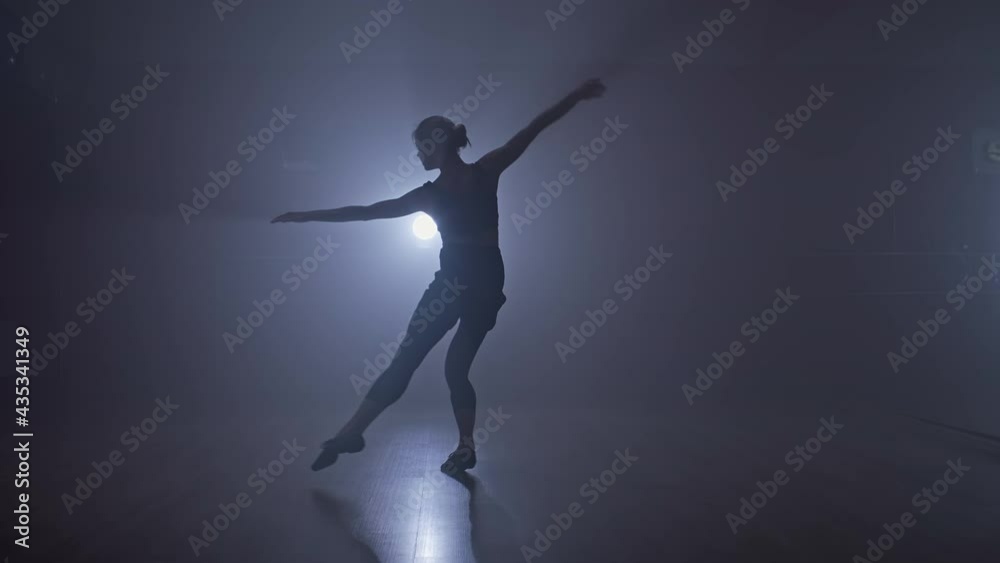 Talented woman performing modern dance in dark studio. Ballerina dances contemporary choreography at smoky stage. Full length in 4K, UHD Talented woman performing modern dance in dark studio. Ballerina dances contemporary choreography at smoky stage. Full length in 4K, UHD