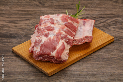 Raw pork ribs served rosemary