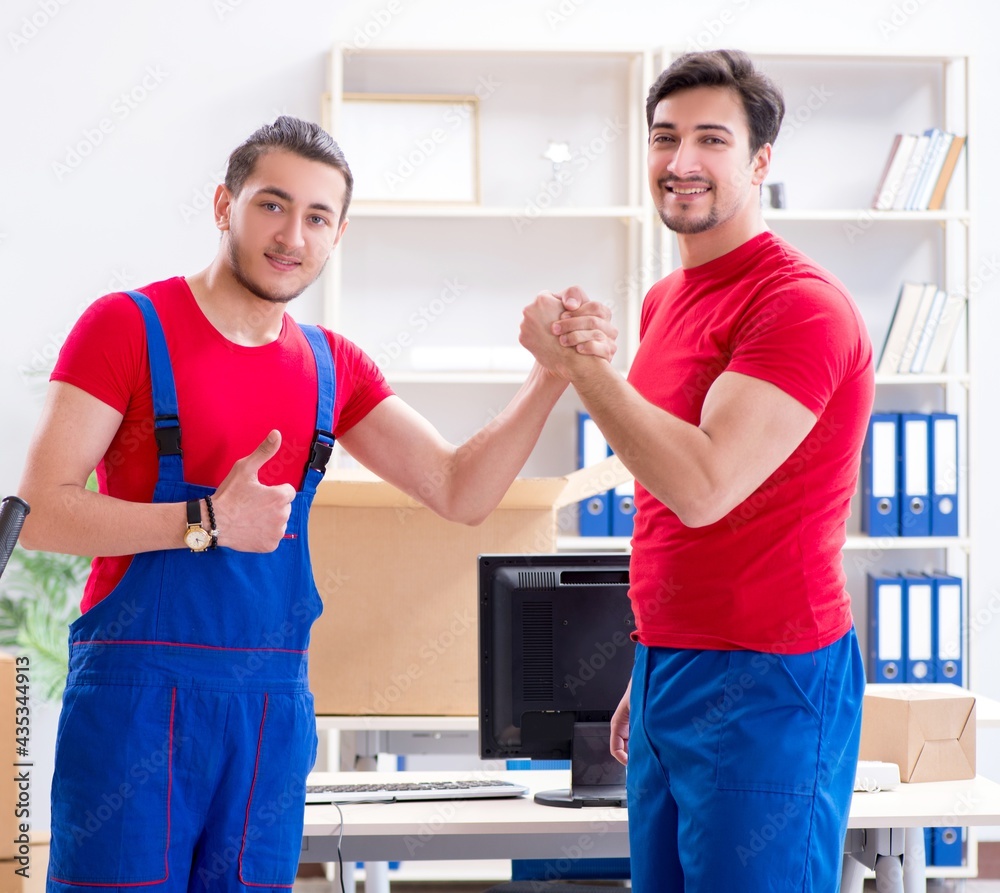 Fototapeta premium Two contractor employees moving personal belongings
