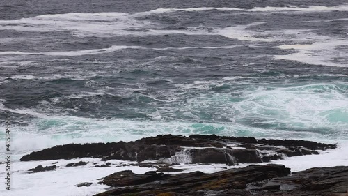 Crashing waves on rocky shoreline, Zapallar, Valparaiso, Chile, handheld shot photo