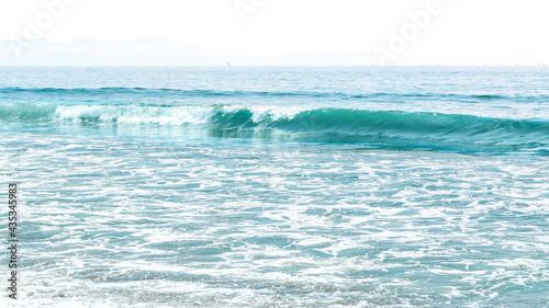 A beautiful sea wave foams and seethes near the shore