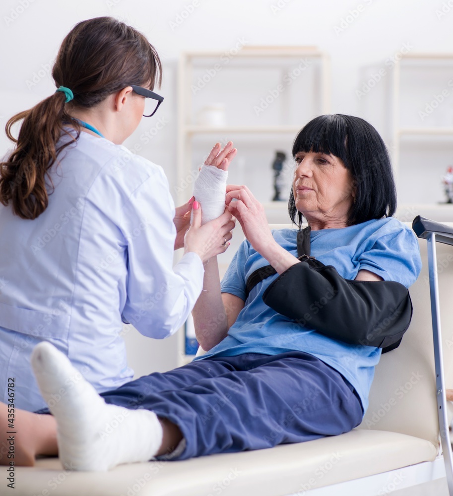 Doctor examining old mature woman after incident Doctor examining old mature woman after incident
