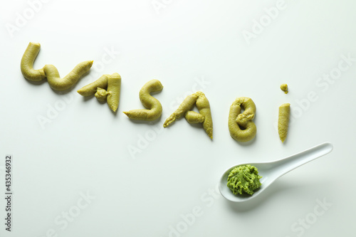Word Wasabi made of wasabi and spoon with wasabi isolated on white background