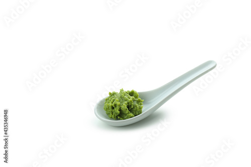 Ceramic spoon with wasabi isolated on white background