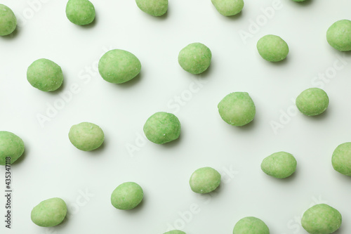 Flat lay with wasabi nuts on white background