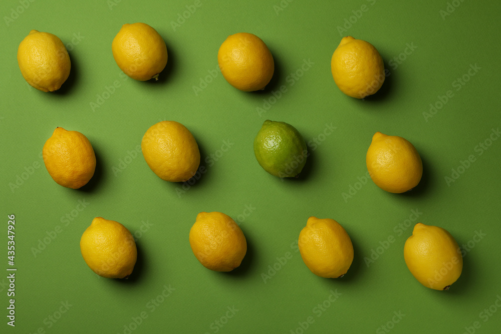 Ripe lemons and lime on green background, top view Ripe lemons and lime on green background, top view