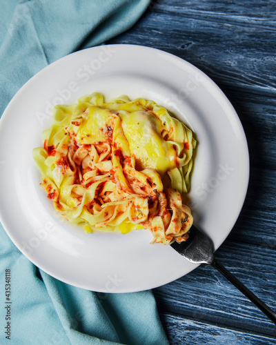 Spaghetti pasta with cheese and pepper, served in a white plate over rustic gray wooden table. photo