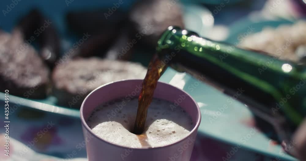 Beer pour into picnic glass female hands busy full bbq table close up Beer pour into picnic glass female hands busy full bbq table close up