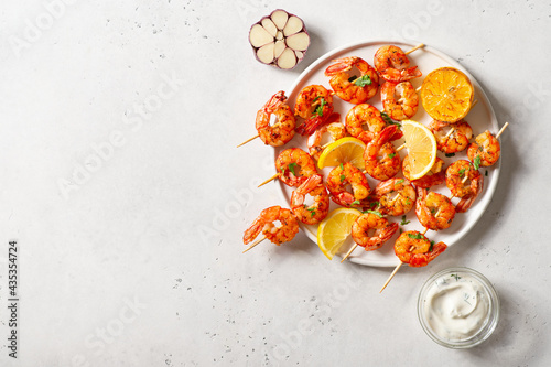 Grilled shrimp with garlic and lemon on white background photo